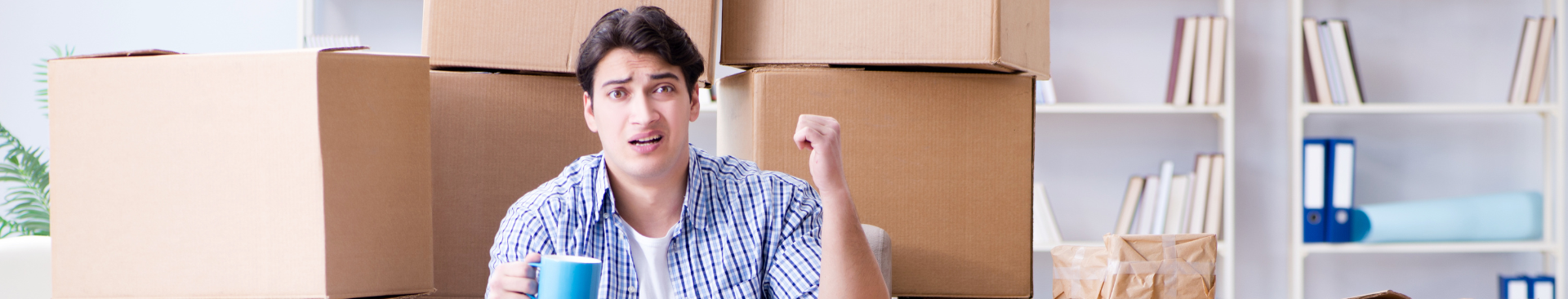 Image of young man moving into apartment