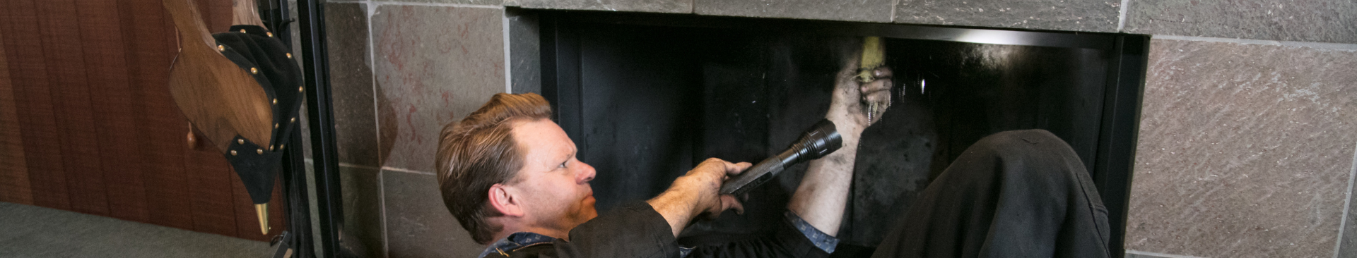 Image of technician cleaning a chimney